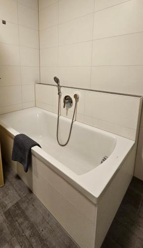 a bath tub with a shower in a bathroom at MY HOME 23 Nr 8 in Villingen-Schwenningen