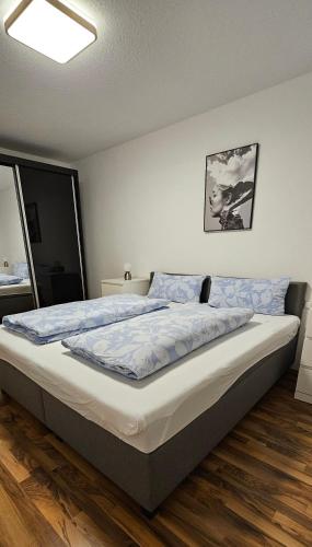 a bedroom with a large bed with blue sheets at MY HOME 23 Nr 8 in Villingen-Schwenningen