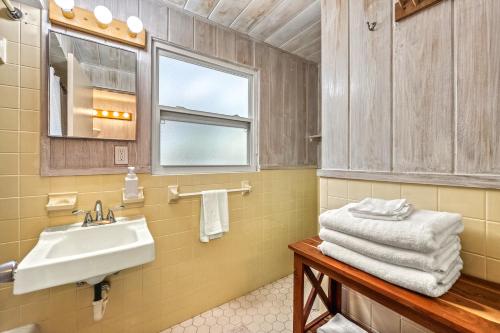 a bathroom with a sink and a mirror at Gulf Front Escape on the Beach with Shared Lounging Deck & Pool in Englewood