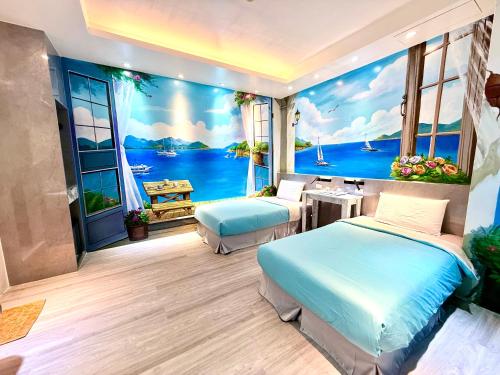 two beds in a room with a view of the ocean at 船屋親子特色民宿Ship House in Xiaoliuqiu