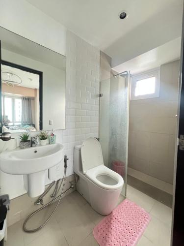 a bathroom with a toilet and a sink and a shower at Abreeza Tower 1 in Davao City