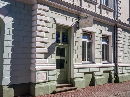 a building with a green door on a street at Studio28 Boutique Rooms in Pärnu