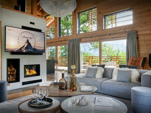a living room with a couch and a fireplace at Chalet RevAlp - OVO Network in Combloux