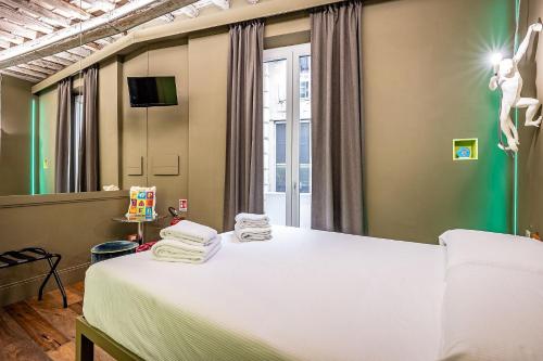 a bedroom with a bed with towels on it at Pop Tower Florence in Florence