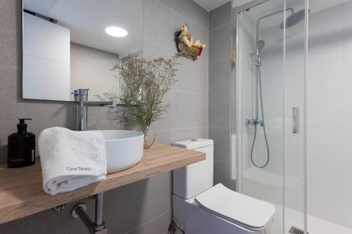 a bathroom with a sink and a toilet and a shower at Casa Tabera - Sun Club Playa del Águila in Playa del Aguila