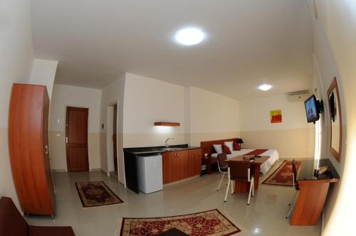 a room with a kitchen and a living room at Byblos Guest House in Jbeil