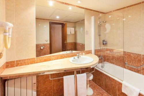 a bathroom with a sink and a shower at Port Denia in Denia