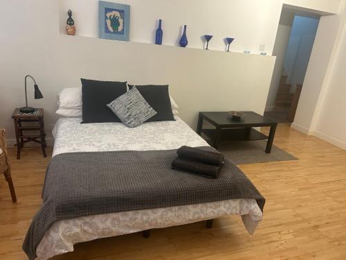 a bedroom with a bed and a table with vases at Cozy 1 Bedroom Basement Flat in London