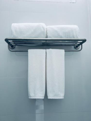 a pile of towels on a shelf in a bathroom at Sarona House 3 in Ban Thalat Choeng Thale