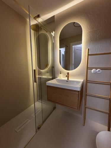 a bathroom with a sink and a mirror at Apartament Cicha Przystań w centrum Zakopanego APARTZAKOP in Zakopane