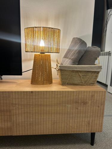 a lamp sitting on top of a table with a tv at Guest House Rila in Govedartsi