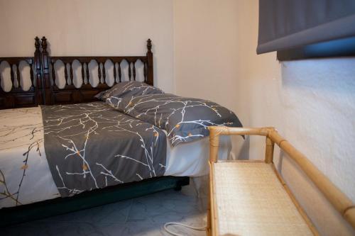 a bedroom with a bed with a wooden head board at Toledo Downtown - Apartment for 6 in Toledo