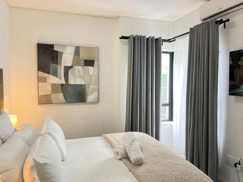 Postel nebo postele na pokoji v ubytování Leafy Lux Apartment