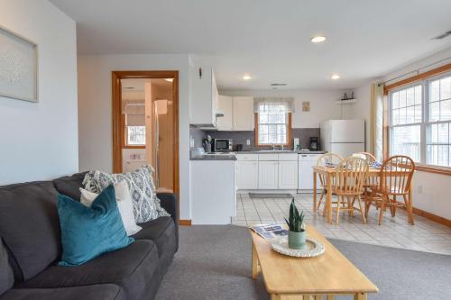 a living room and kitchen with a couch and a table at 12217 - Beautiful Views of Cape Cod Bay Access to Private Beach Easy Access to P-Town in Truro