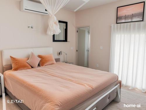 a bedroom with a large bed with orange pillows at Walawa cottage udawalawe in Udawalawe