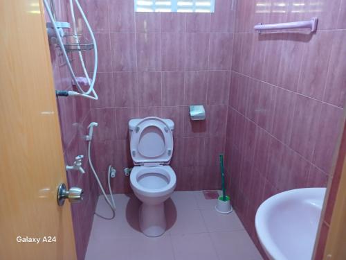 a bathroom with a toilet and a sink at Walawa cottage udawalawe in Udawalawe