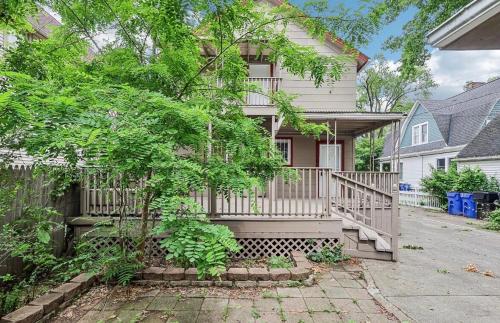 a house with a porch and a fence at Perfect staycation in Ohio City, walk to W 25 st in Cleveland