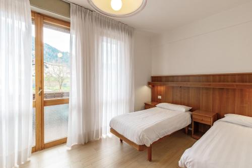 Ένα ή περισσότερα κρεβάτια σε δωμάτιο στο Albergo Belvedere