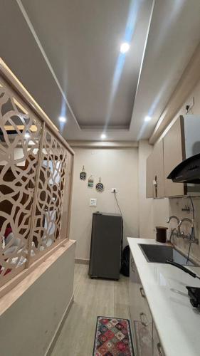 a kitchen with a sink and a counter top at Infinium Stay in Rishīkesh