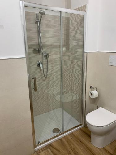 a shower stall in a bathroom with a toilet at Titti's Room in Casteldaccia