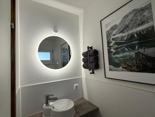 a bathroom with a sink and a mirror at Ferienwohnung Leni in Siegsdorf