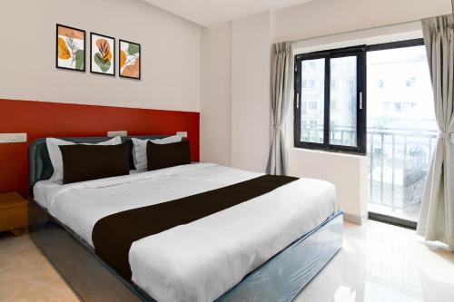 a bedroom with a large bed and a large window at Hotel O Infocity Square Road Bhubaneswar Formerly Avigna Premium in Bhubaneshwar