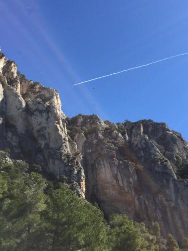 an airplane is flying over a mountain at Hotel Cresol in Calaceite