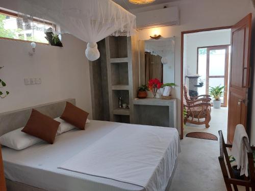 a bedroom with a large white bed in a room at CosyNsurf in Matara