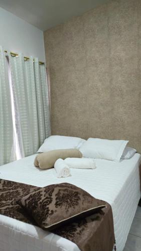 a bedroom with two beds with white sheets and towels at Hotel Familiar in Salinas