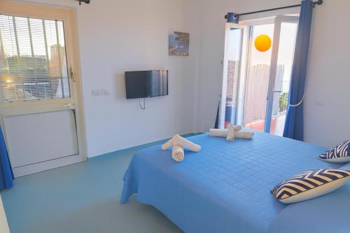 a bedroom with a blue bed with teddy bears on it at B&B La Danza del Mare in Anacapri