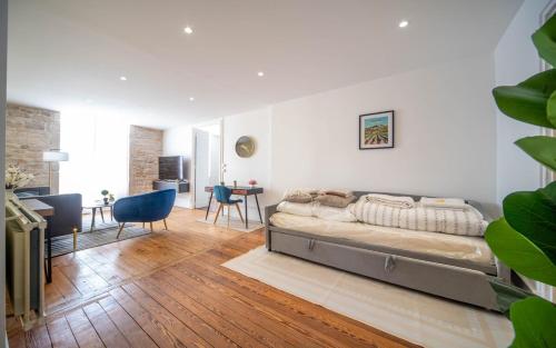 a bedroom with a bed and a living room at Place Carnot in Tournus