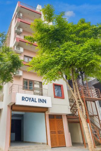 a building with a royal inn sign in front of a tree at Royal inn in Patna