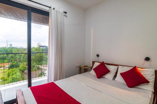 a bedroom with a bed and a large window at Crescent Luxe Stays in Ernakulam
