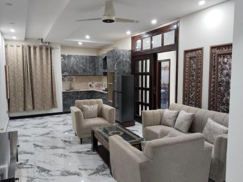 a living room with couches and a table at Royal Apartments-One Bed Apartments in Islamabad