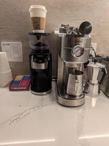 a coffeemaker and a coffee maker on a counter at The Cosmo Outstand NYC - Private Room near Times Square in New York