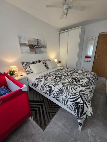 a bedroom with a bed with a black and white comforter at Apartments Lora in Vir