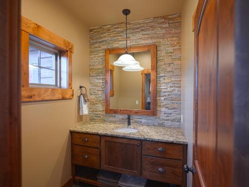 a bathroom with a sink and a mirror at Spring Shores Lodge - Luxury Mountain Experience! in Ashton
