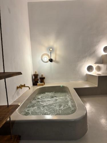 a bath tub in a bathroom with at Cycladic Home Vorea in Ios Chora