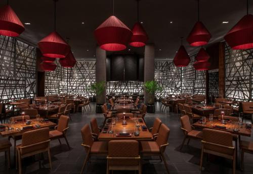 a restaurant with tables and chairs and red lamps at MGM Grand in Las Vegas
