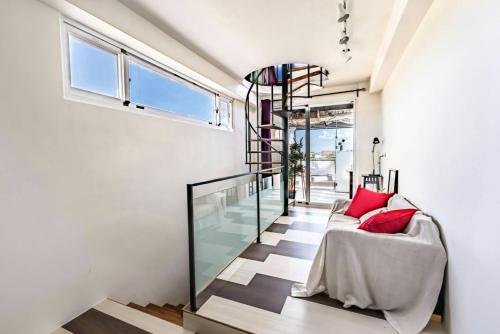 a living room with a couch and a glass wall at Malibu OceanView Homestay in Magong