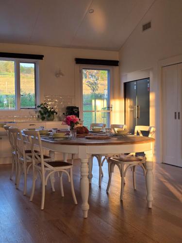 a dining room with a table and chairs at Unwind at BlueWrenHill in Gloucester