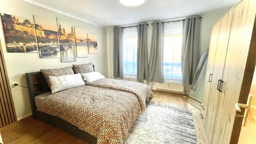 a bedroom with a bed and a large window at Charming accommodation in Radebeul Altkötzenbroda in Radebeul