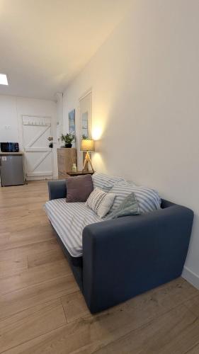 a blue couch sitting in a living room at Le Plein Sud - Carqueiranne in Carqueiranne