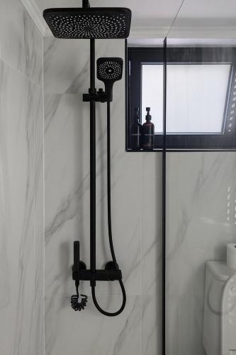 a shower in a bathroom with a black shower head at Mi Casa Chios in Chios