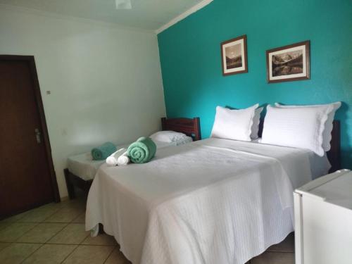 Postel nebo postele na pokoji v ubytování Pousada Cantinho D'Abrantes - Próximo as Melhores Praias de Ilhabela - Veloso e Curral