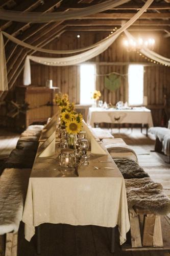 a long table with flowers on it in a room at HALI - Hideaway in Raseborg
