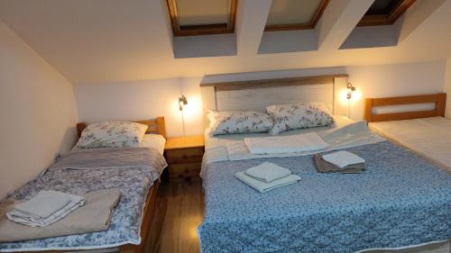 a bedroom with two beds with towels on them at Apartman Neron in Soko Banja
