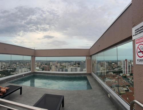 a swimming pool on the top of a building at Red Building Apartment in Bauru