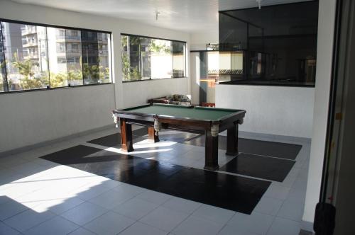 a room with a pool table on a tile floor at Joalpa Hotel Cabo Frio in Cabo Frio