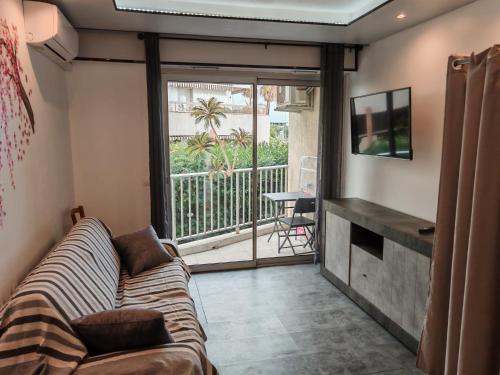a living room with a couch and a balcony at Dolce vita in Menton